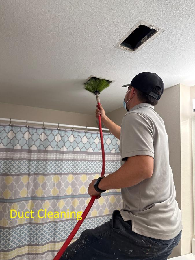Technician cleaning air duct with rotary brush — duct cleaning service Panama City