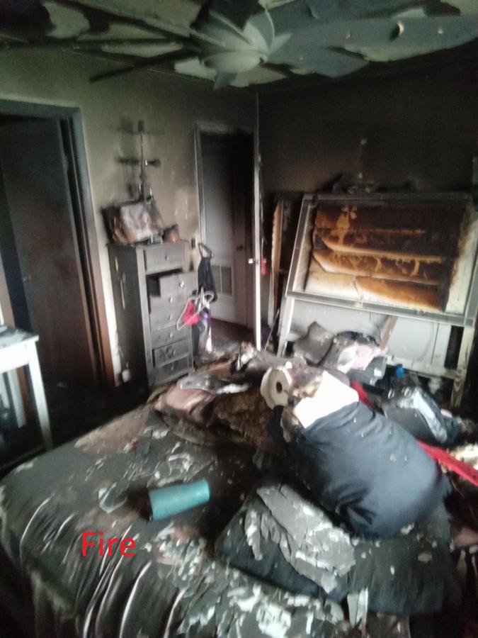 Fire damaged bedroom with charred ceiling and destroyed furniture — fire cleanup Florida
