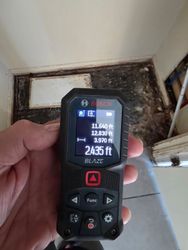 Laser Moisture Measurement — Laser-based non-invasive moisture measurement in progress — used in luxury 30A homes where minimal disturbance is critical.